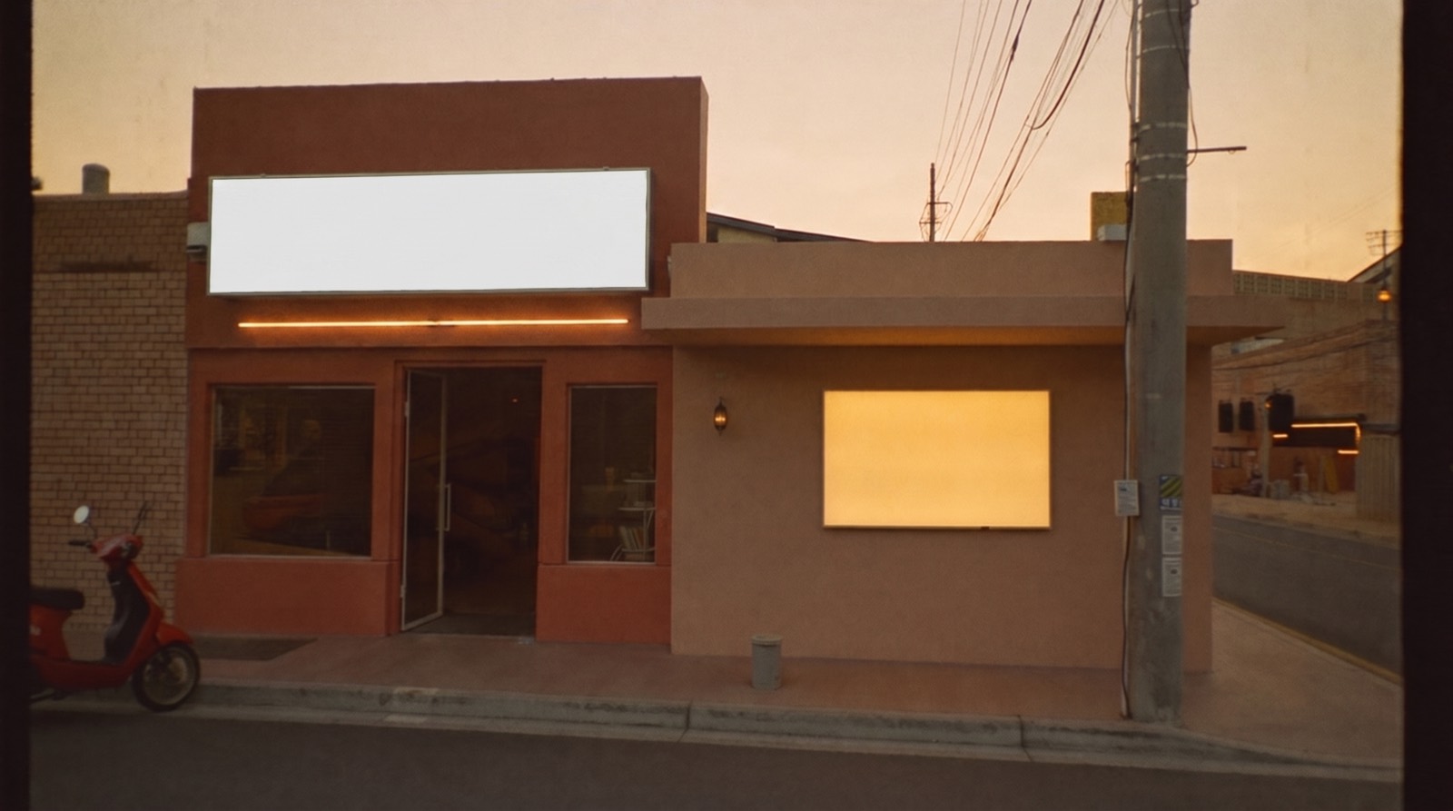 A warm-lit UAE shopfront at dusk